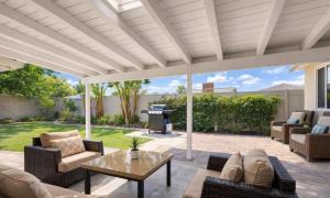 a patio with couches and a table and a grill at Disneyland Dream Villa 5 BR 3 BA Arcade Games in Anaheim