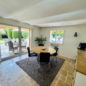a dining room with a table and chairs at Villa Sunlight Mougins in Mougins