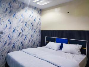 a bedroom with a large bed with a mural on the wall at Regent Hotels and Suites in Oshogbo