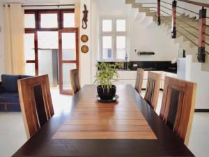 a dining room table with a potted plant on top at Green villa in Galle