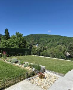 a garden with a hill in the background at Vila Atlantida in Velika