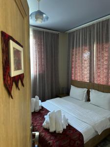 a bedroom with a bed with towels on it at Amrots Deghceni - Boutique Castle Stay in Dilijan