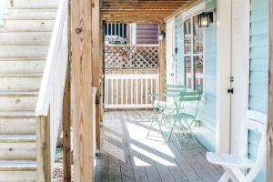 a porch with chairs and a table on a house at The Hunker Down in Staunton