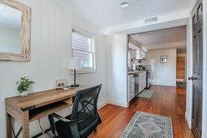 a home office with a wooden desk and a kitchen at The Hunker Down in Staunton