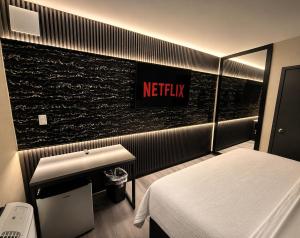 a hotel room with a netflix sign on the wall at The Vine Hotel Bronx New in Bronx +12 photos