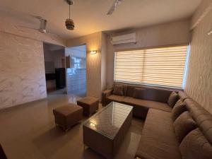 a living room with a couch and a table at Pindora Stays in Ludhiana