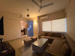 a living room with a couch and a table at Pindora Stays in Ludhiana +10 photos