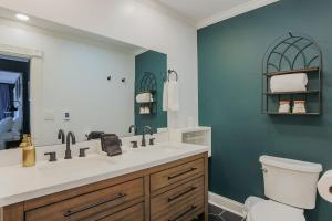 a bathroom with a sink and a toilet and a mirror at The Wayne Shire in Waynesboro