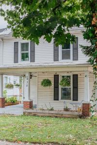 a white house with a bench in front of it at The Wayne Shire in Waynesboro