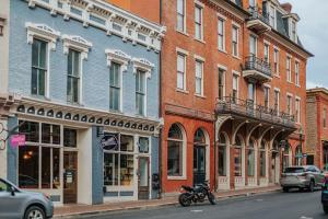 a motorcycle parked on a street in front of buildings at The Social Loft in Staunton