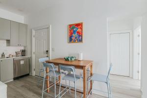 a kitchen with a table and chairs in a room at The Social Loft in Staunton