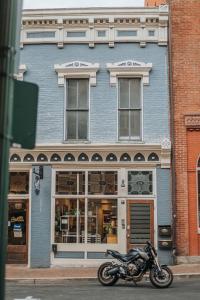 a motorcycle parked in front of a blue building at The Social Loft in Staunton