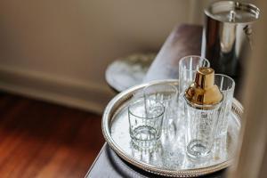 a bottle of perfume and glasses on a table at The Woodward in Staunton