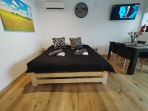 a bedroom with a bed with pillows and a table at Mieszkanie Janowice in Janowice Wielkie
