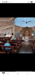 a view of a church with wooden benches and a ceiling at Love Villa in Kottiyam