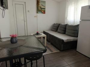 a living room with a couch and a table at Vila Katerina Dojran in Star Dojran +6 photos