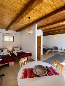 a room with two beds and a table and chairs at Pensiune Family & Friends Crit 168 in Criţ