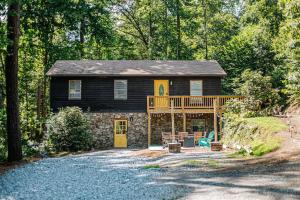 a black house with a deck and a porch at Tucked Inn: Lower Unit in Nellysford