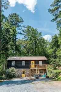 a large log cabin with a porch and a deck at Tucked Inn: Lower Unit in Nellysford +25 photos