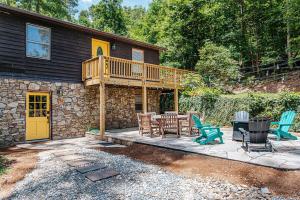 a house with a deck and chairs on a patio at Tucked Inn: Lower Unit in Nellysford