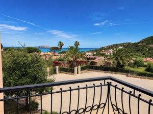 a balcony with a view of the ocean at Piazzetta Dei Pini Two Bedroom Apartment 100 m from the Beach in Baja Sardinia +6 photos