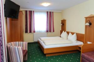 Postel nebo postele na pokoji v ubytování Hotel Posauner