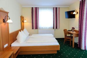 Postel nebo postele na pokoji v ubytování Hotel Posauner