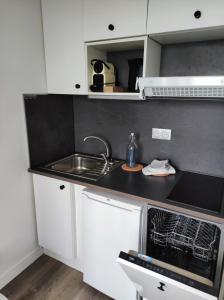 a small kitchen with a sink and a stove at Vue Mer sur Juno Beach - Studio in Courseulles-sur-Mer +9 photos