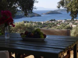 a bowl of fruit sitting on a wooden table at Villas Zoe in Skiathos