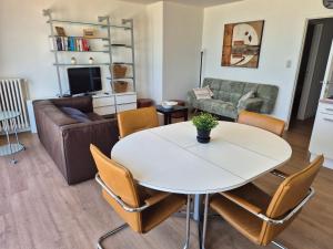 a living room with a table and a couch at Sealview Nevada in Koksijde