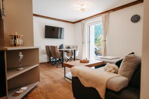 a living room with a couch and a table at Longaview in Weisspriach