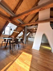 a dining room with a table and chairs and wooden ceilings at Platzl am Malteser in Amberg +54 photos