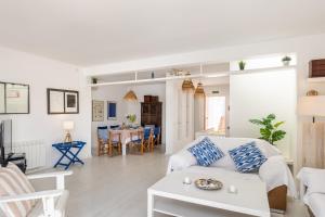 a living room with a white couch and a table at Ancla 1 in Port d'Andratx