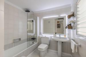 a white bathroom with a toilet and a sink at Ancla 1 in Port d'Andratx +28 photos