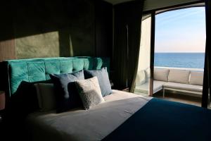 a bedroom with a bed with a view of the ocean at Bela Vista Suites in Carvoeiro