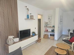 a living room with a flat screen tv on a wall at Bellver 1, Ciutadella-Cala Blanca in Cala Blanca