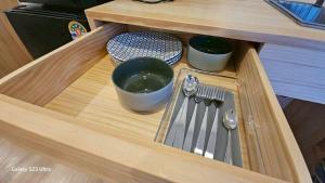 a wooden drawer with utensils on top of it at Beas Place Klong Dao in Ko Lanta