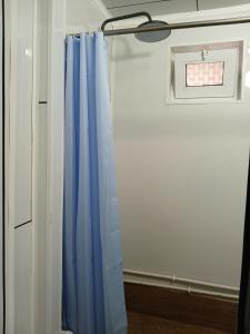 a blue curtain in a room with a window at Мурас хостел in Var-Kyshtak