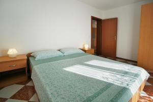 Postel nebo postele na pokoji v ubytování Apartments AVA