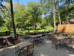 a group of tables and chairs in a park at Haus Waldesruh in Nettetal