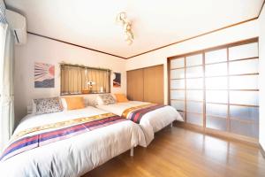 a bedroom with a large bed and a window at Coucou! in Takasaki +33 photos