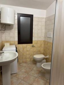 a bathroom with a toilet and a sink at Casa Sant'Antonio in Orosei