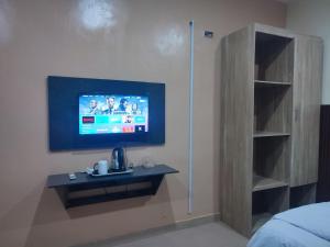 a room with a tv on a wall at Regent Hotels and Suites in Oshogbo