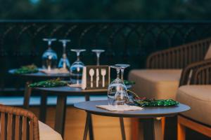 a couple of tables with wine glasses on them at Hemingway's Hotel in Entebbe