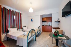 a small room with two beds and a table at Kalpazo Rental Kaya Stays in Golem +44 photos