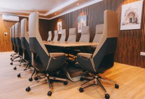 a conference room with a long table and chairs at Hemingway's Hotel in Entebbe +51 photos