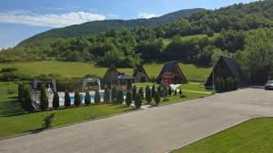 a playground in a field next to a mountain at Etno Selo Relax in Šipovo