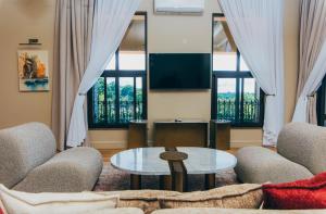 a living room with a couch and a table at Hemingway's Hotel in Entebbe