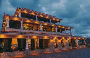a large building with lights on top of it at Hemingway's Hotel in Entebbe