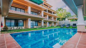 an image of a swimming pool in front of a house at Hemingway's Hotel in Entebbe